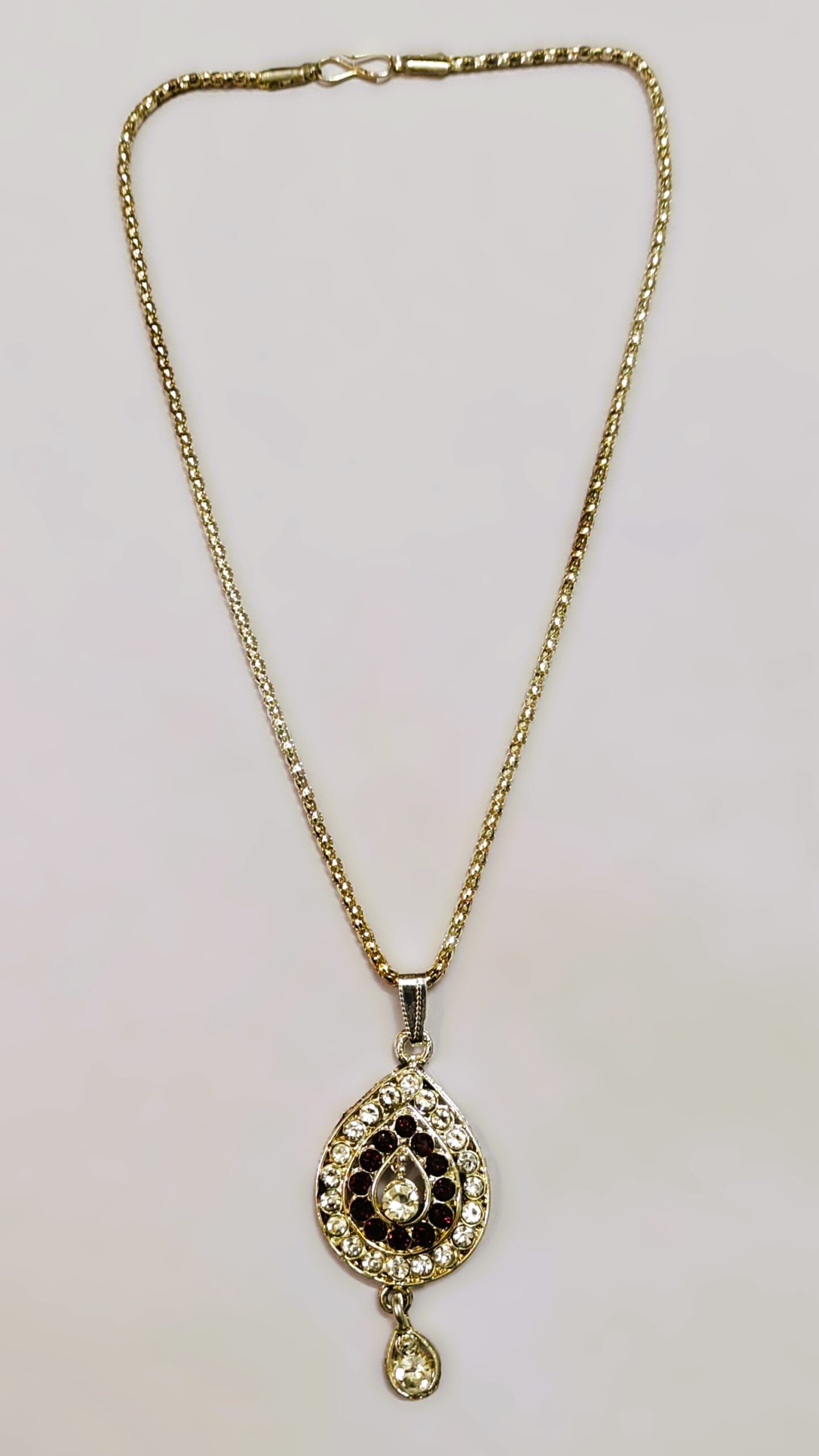 Traditional Indian Gold-Plated Teardrop Pendant Necklace with black and white stones and gold-toned metalwork