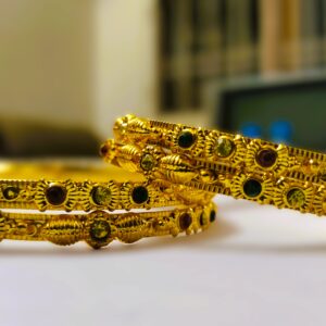 A stunning set of Rajwadi Regal Gold-Plated Bangle Set, adorned with vibrant gemstones and intricate designs.