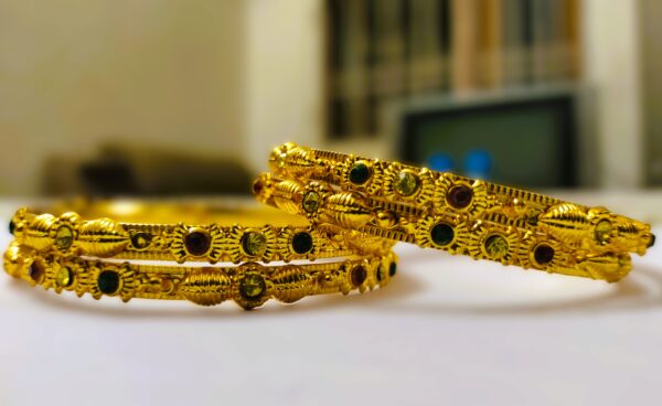 A stunning set of Rajwadi Regal Gold-Plated Bangle Set, adorned with vibrant gemstones and intricate designs.