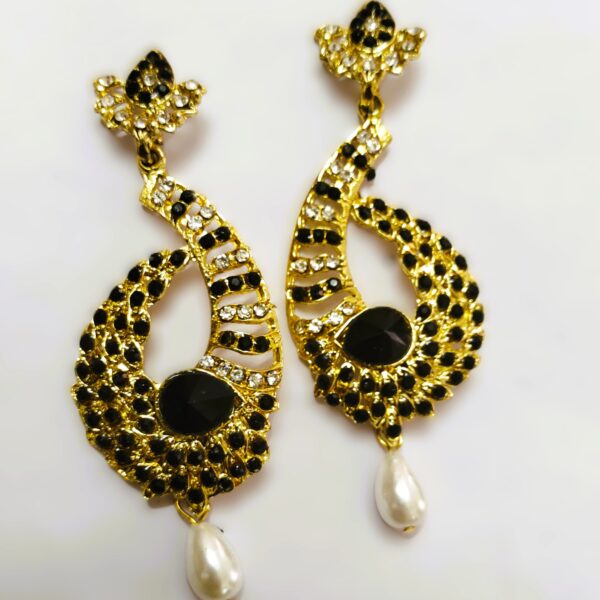 Intricate gold-toned metalwork on the Rajasthani Peacock-Inspired Drop Earrings