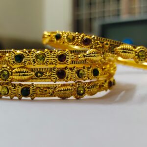 A stunning set of Rajwadi Regal Gold-Plated Bangle Set, adorned with vibrant gemstones and intricate designs.