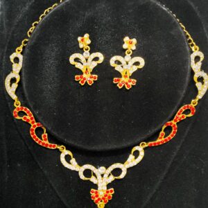 A stunning Jaipur Crimson Rhapsody Bridal Jewelry Set, featuring a necklace, earrings, maang tika, and choker adorned with red and white stones.