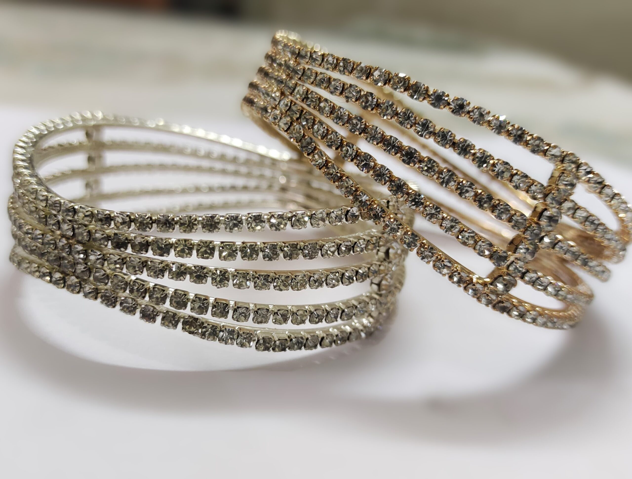 A stunning Jaipur Royal Diamond-Studded Bangle Set, featuring multiple gold-plated bangles adorned with sparkling cubic zirconia stones.