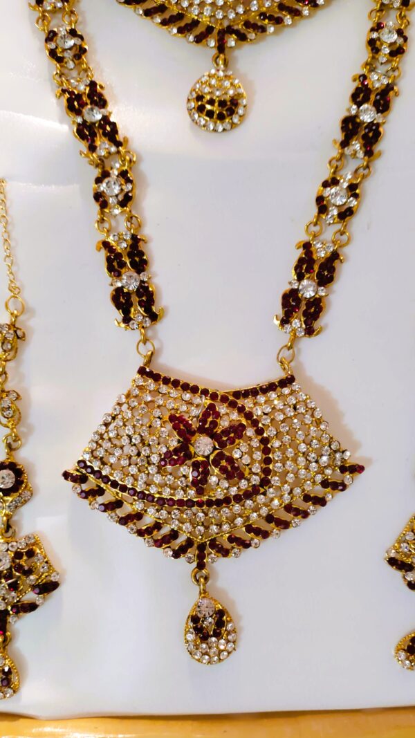 A close-up of the intricate details on the necklace, showcasing the Kundan and American diamond stones.