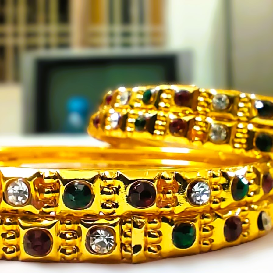 A stunning set of Rajputana Gemstone Bangles, featuring gold-plated metalwork and vibrant gemstones.