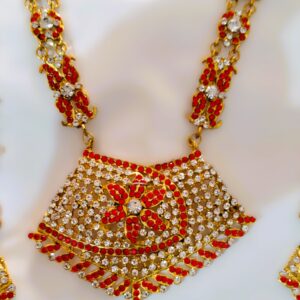 A close-up of the intricate details on the Rajasthani Royal Crimson and Ivory Bridal Necklace, showcasing the crimson and ivory gemstones and gold-plated metalwork.