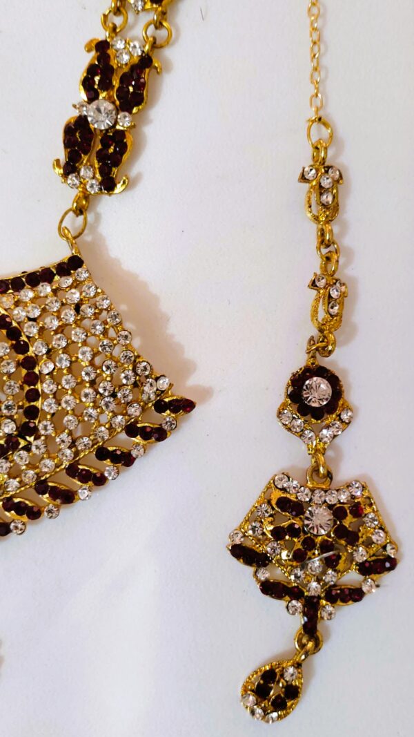 A close-up of the intricate details on the earrings, showcasing the Kundan and American diamond stones.