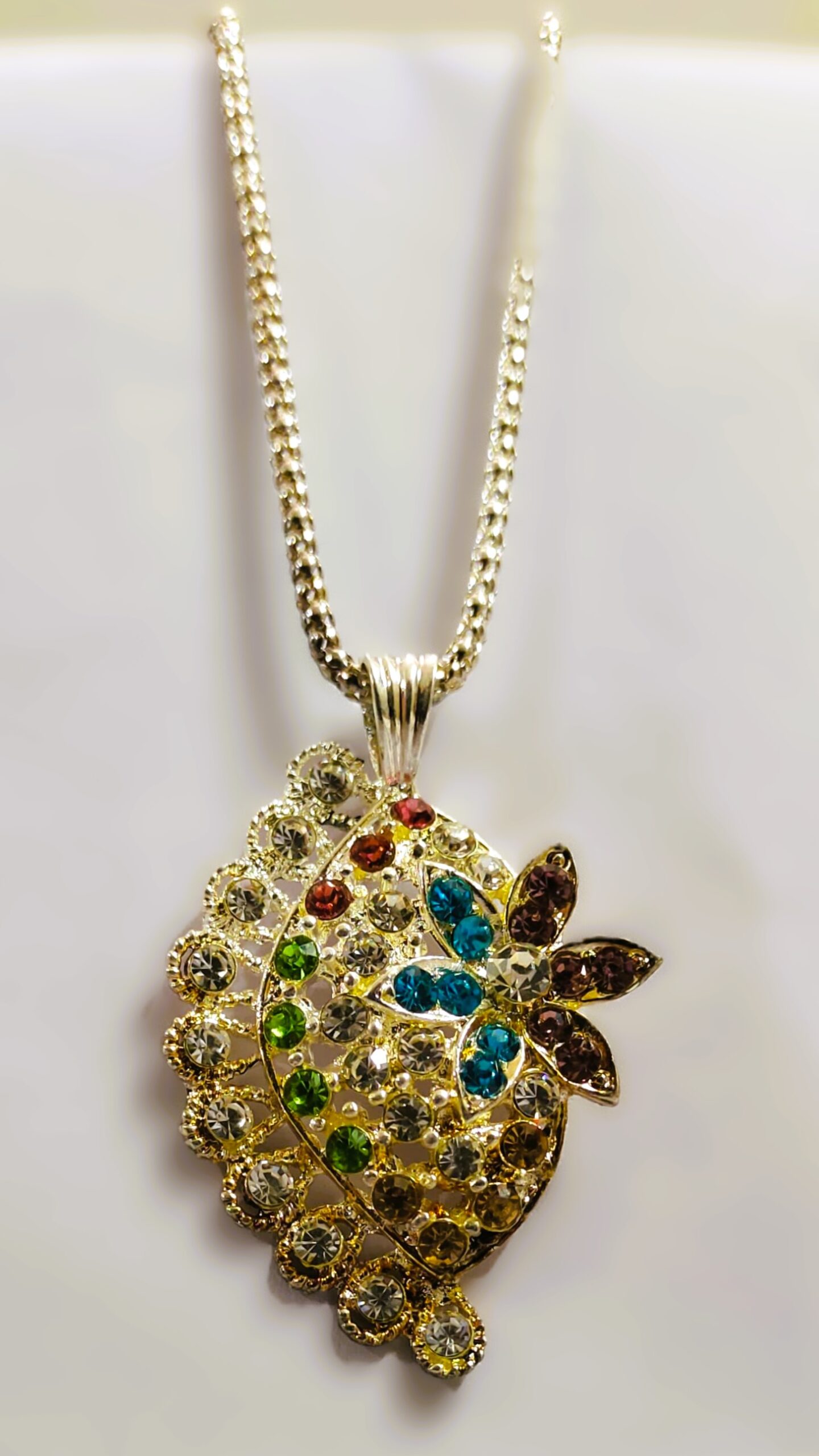 Intricate gold-toned metalwork on the Rajasthani Peacock-Inspired Pendant Necklace