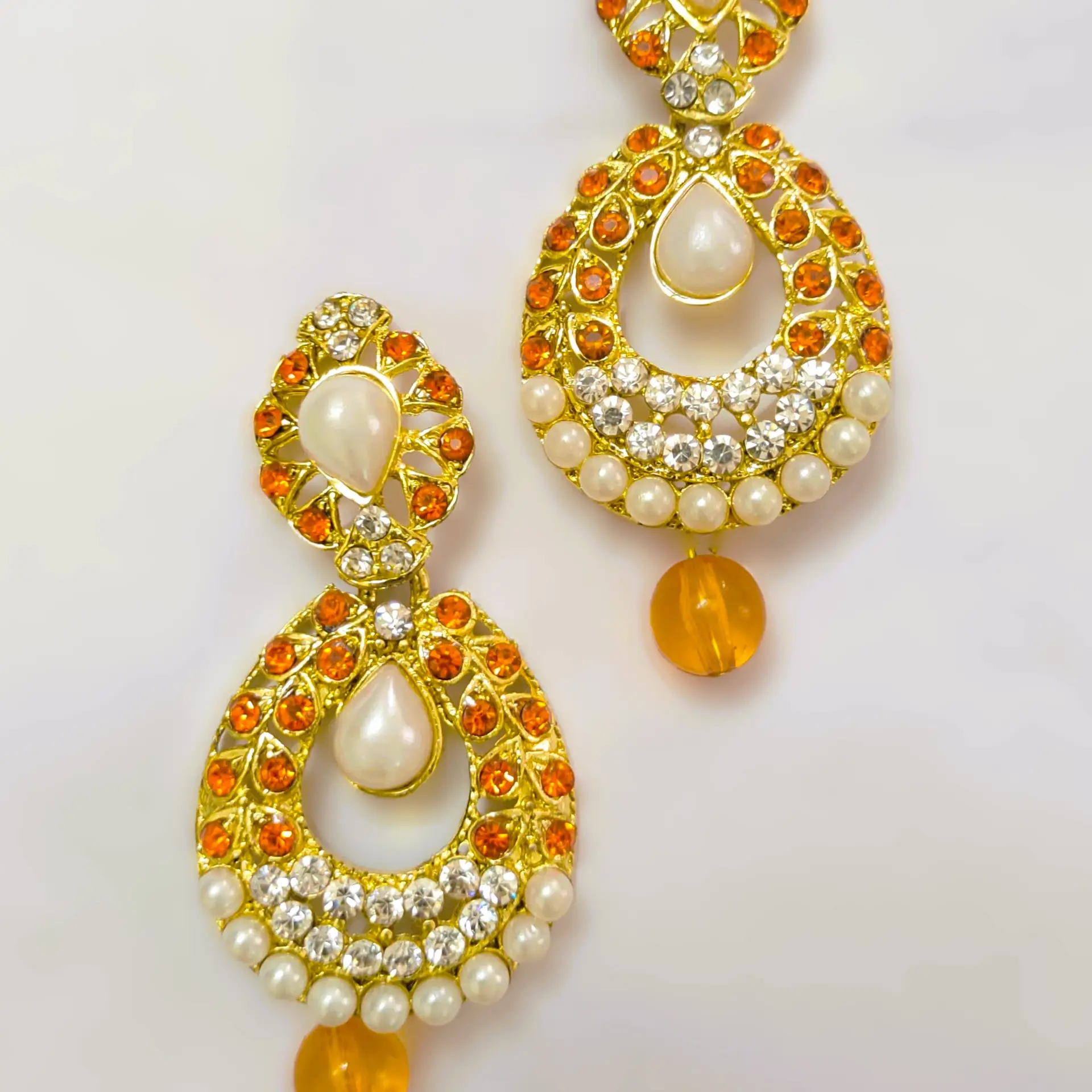 Rajasthani Gold-Plated Drop Earrings with orange stones, pearls, and gold-toned metalwork