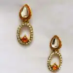 Rajasthani Jhumka Earrings with red and white stones and gold-toned metalwork