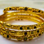 A stunning set of Rajwadi Regal Gold-Plated Bangle Set, adorned with vibrant gemstones and intricate designs.